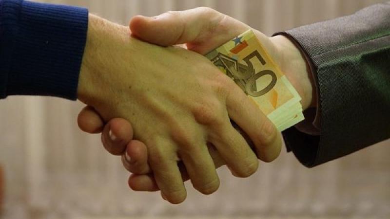 Close-up van handdruk waarbij geld wordt toegestopt