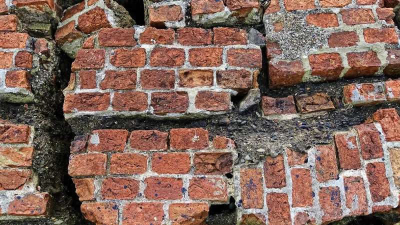 Close-up van schade aan een gemetselde muur